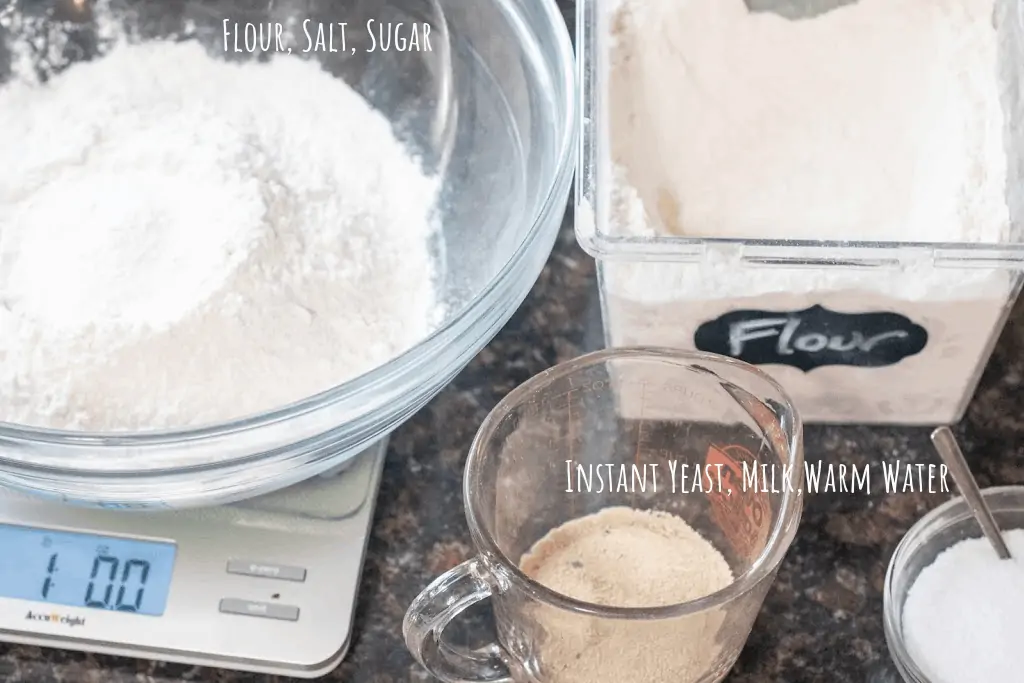 bowl of flour, yeast in cup with milk and water