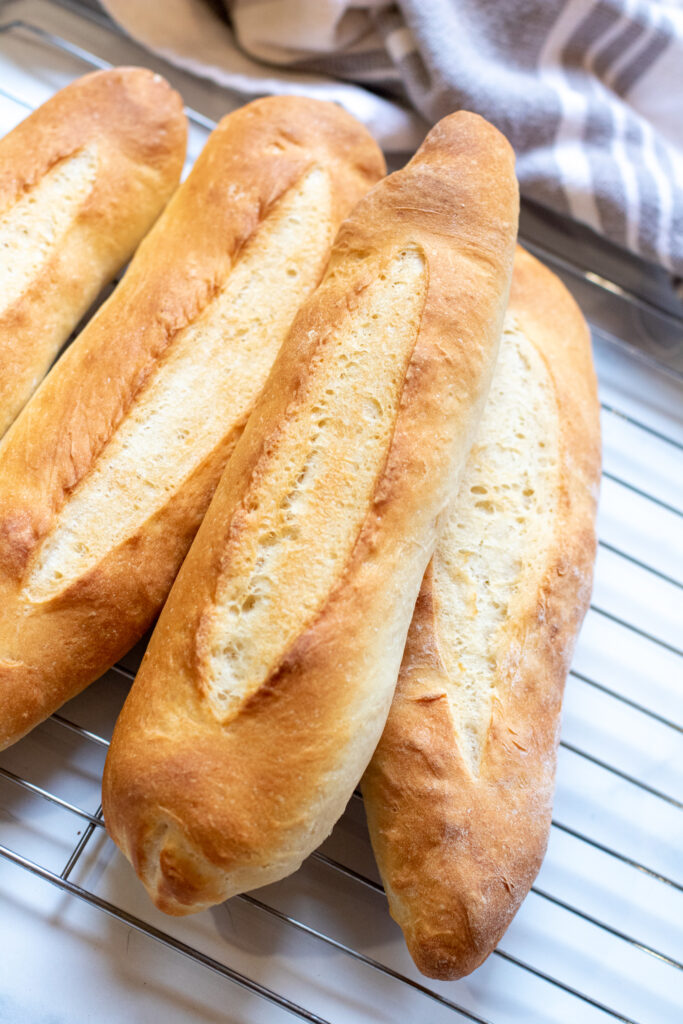 fresh baguettes on a cooling rack