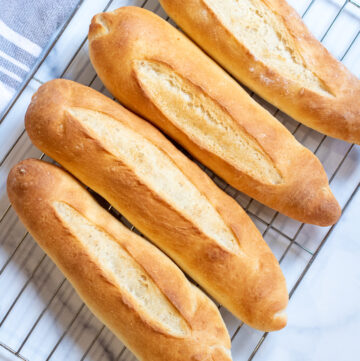 fresh baguettes on a cooling rack.