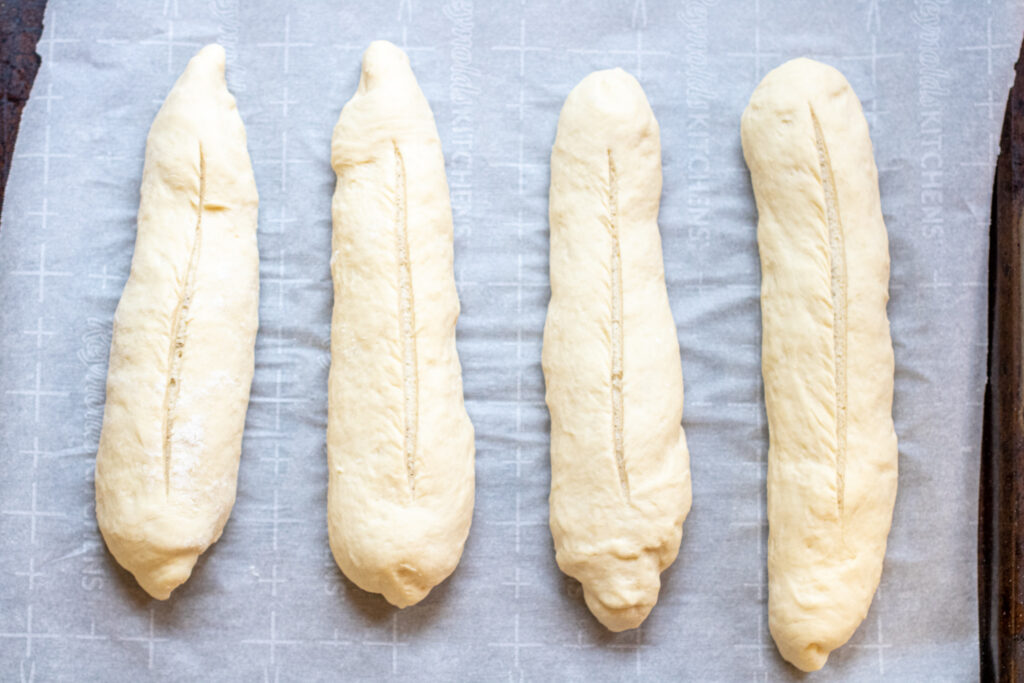 baguette dough shaped and scored