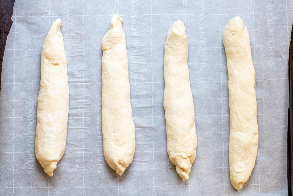 rolled baguette dough on baking sheet