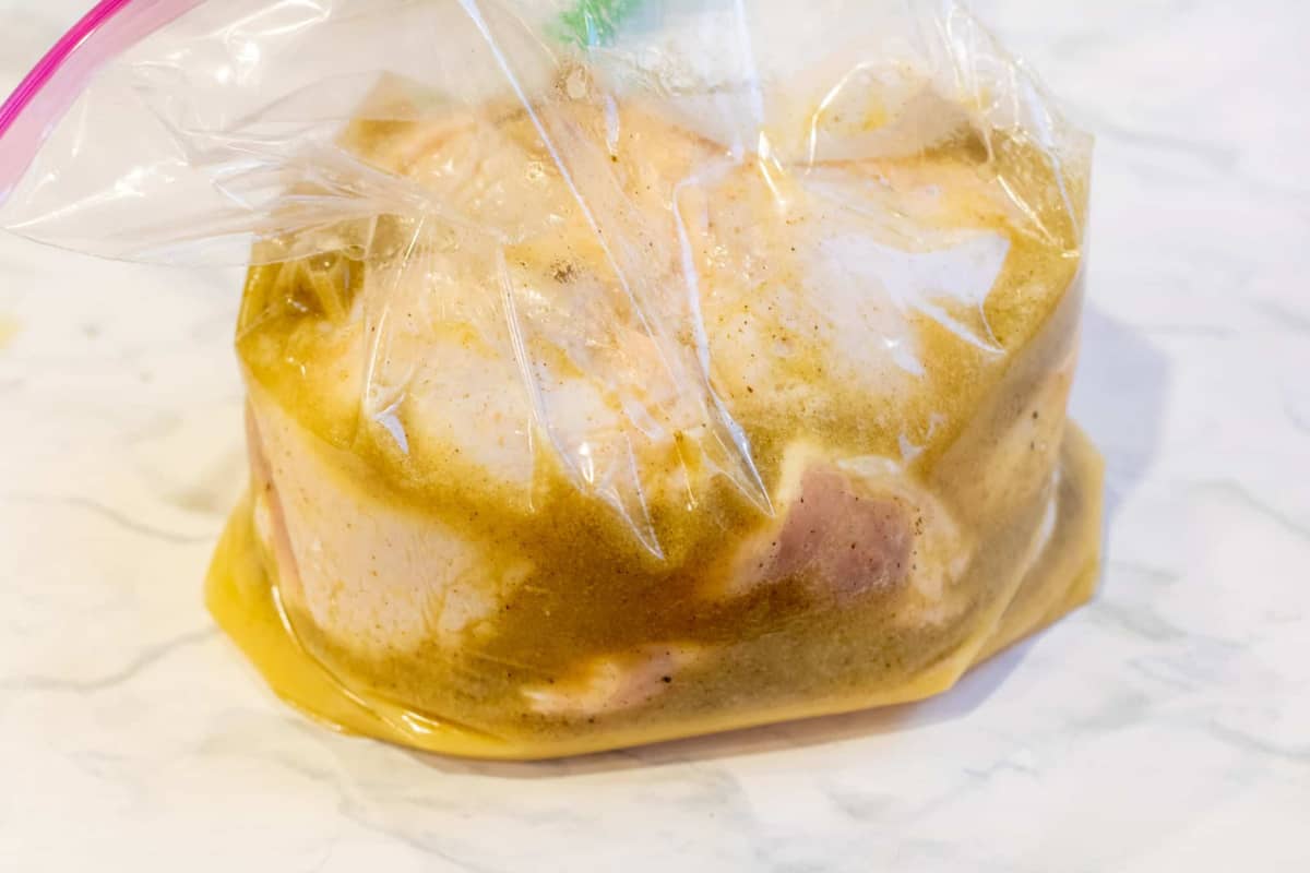 a bag of raw chicken with marinade.