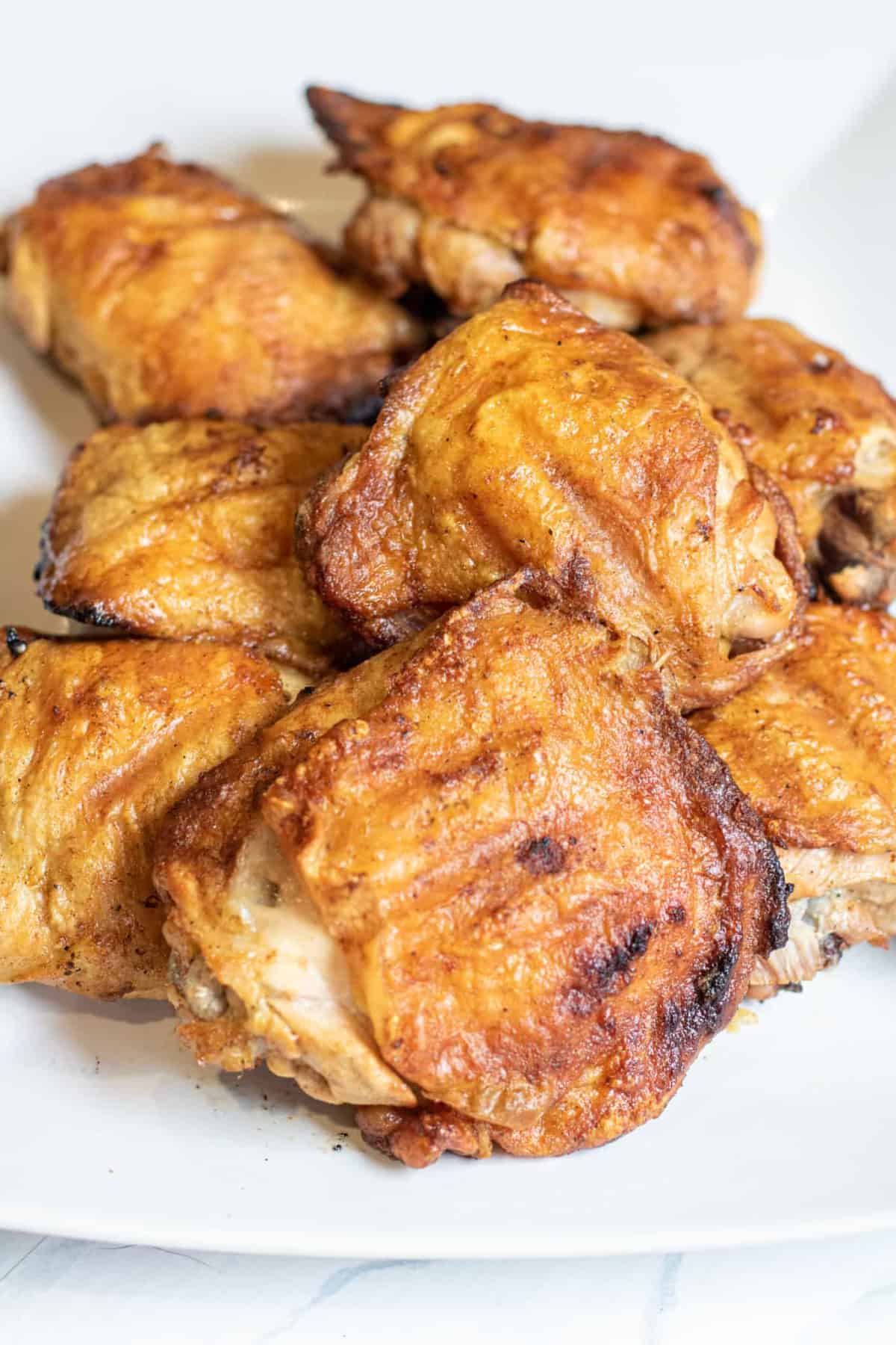 a plate of grilled chicken thighs.