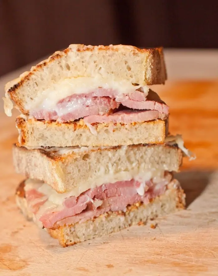 ham and cheese sandwich sliced in half and stacked.