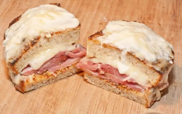 two halves of ham and cheese topped with melted cheese.