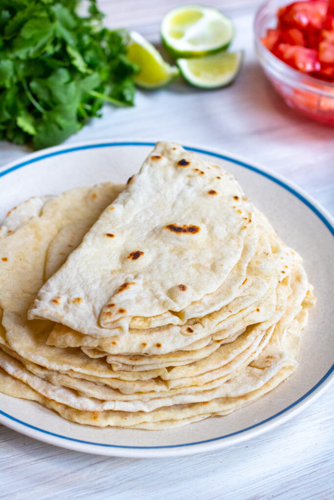 a plate of folded flour tortillas.