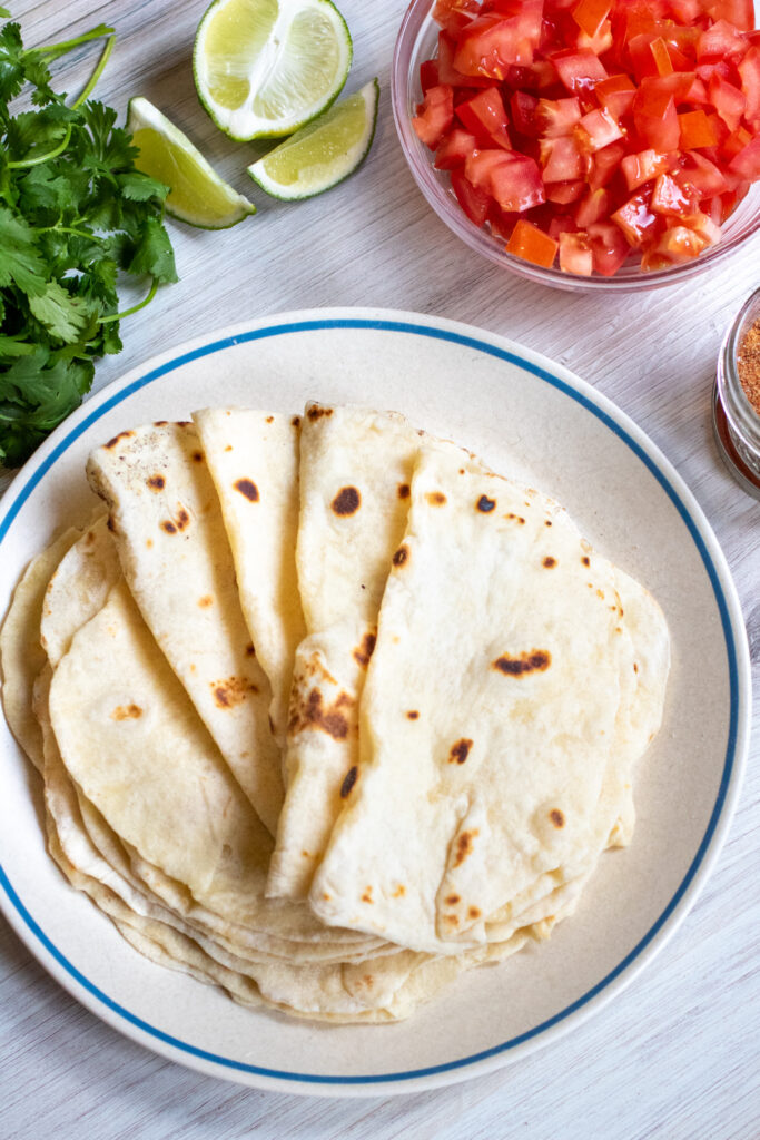 a plate of folded flour tortillas.