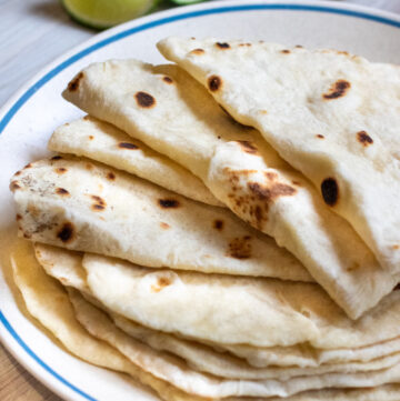 a plate of folded flour tortillas.