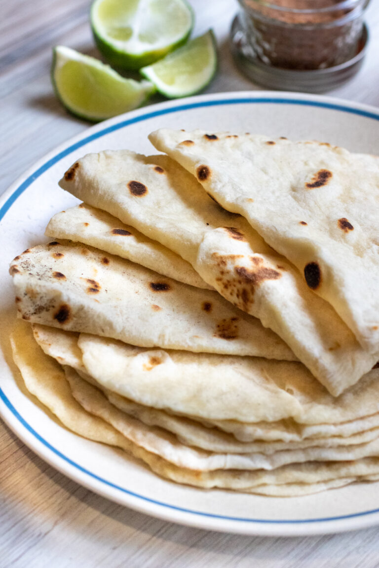 a plate of folded flour tortillas.