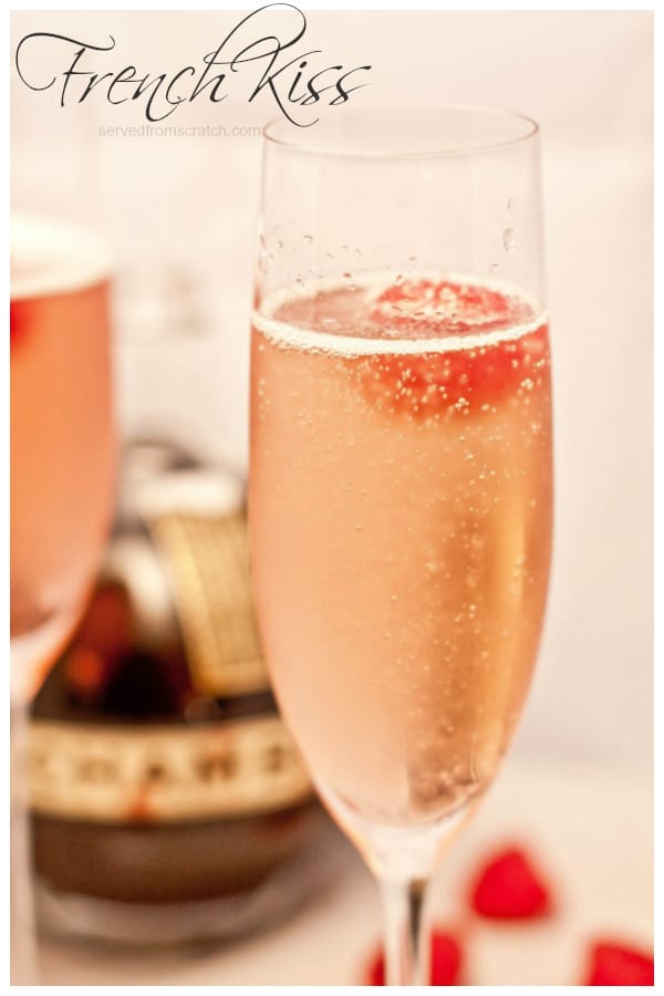 a champagne flute with a pink bubbly drink and a raspberry with Pinterest pin text.