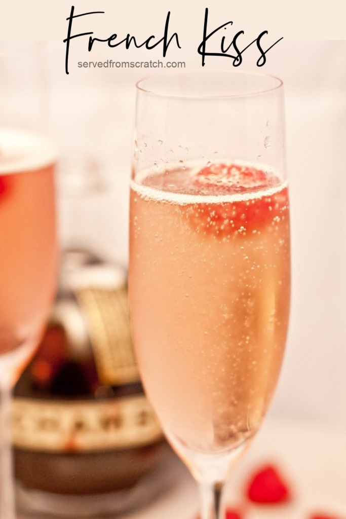 a champagne flute with a pink bubbly drink and a raspberry with PInterest Pin text.