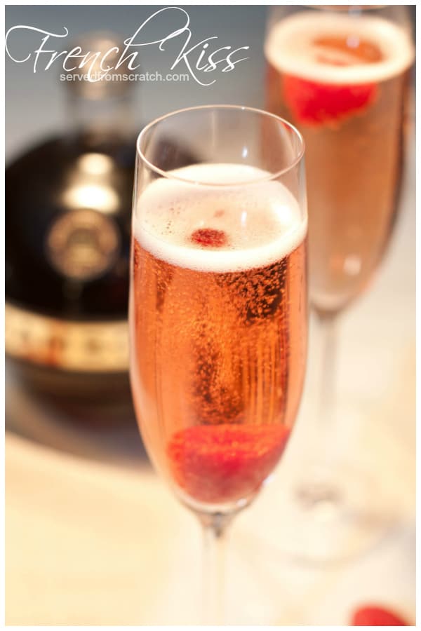 a champagne flute with a pink bubbly drink and a raspberry with Pinterest pin text.