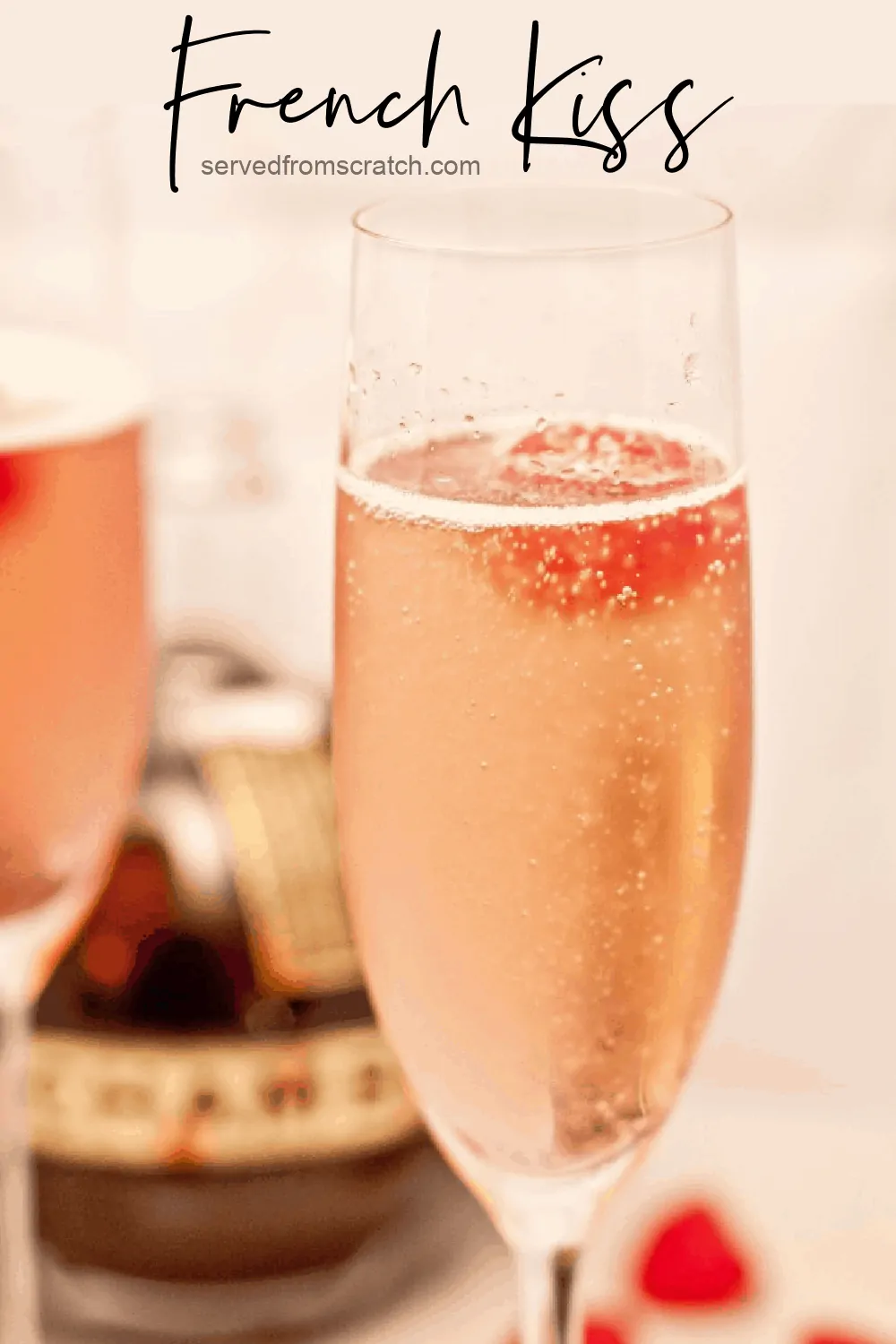 a champagne flute with a pink bubbly drink and a raspberry with Pinterest pin text.