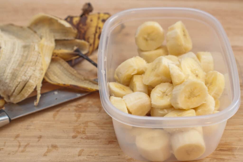 a tupperware of sliced frozen bananas