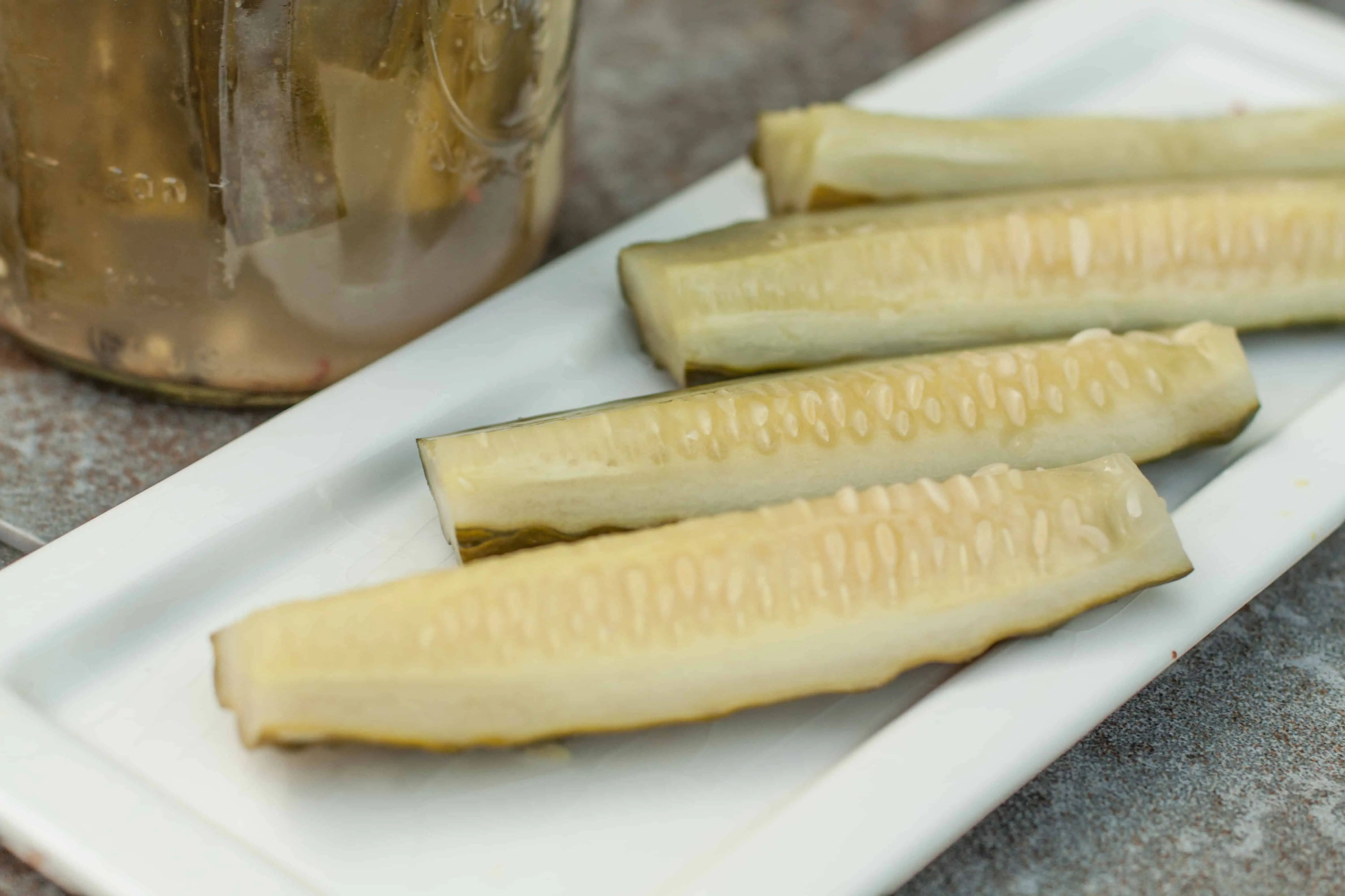 dill pickle spears on a plate.