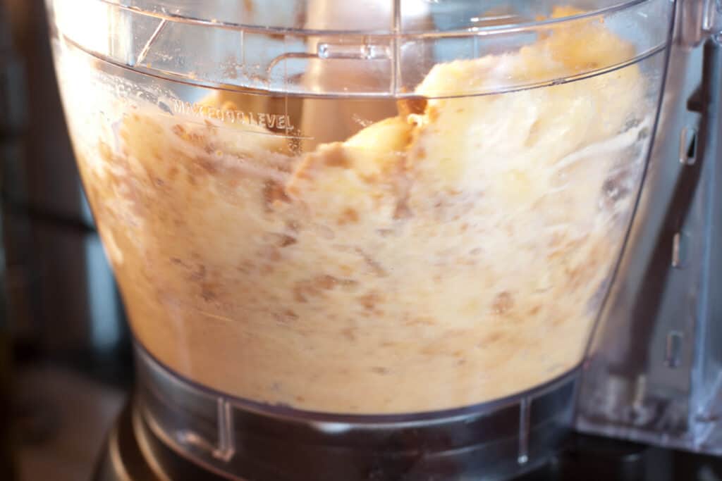 a blender blending peanut butter and bananas.