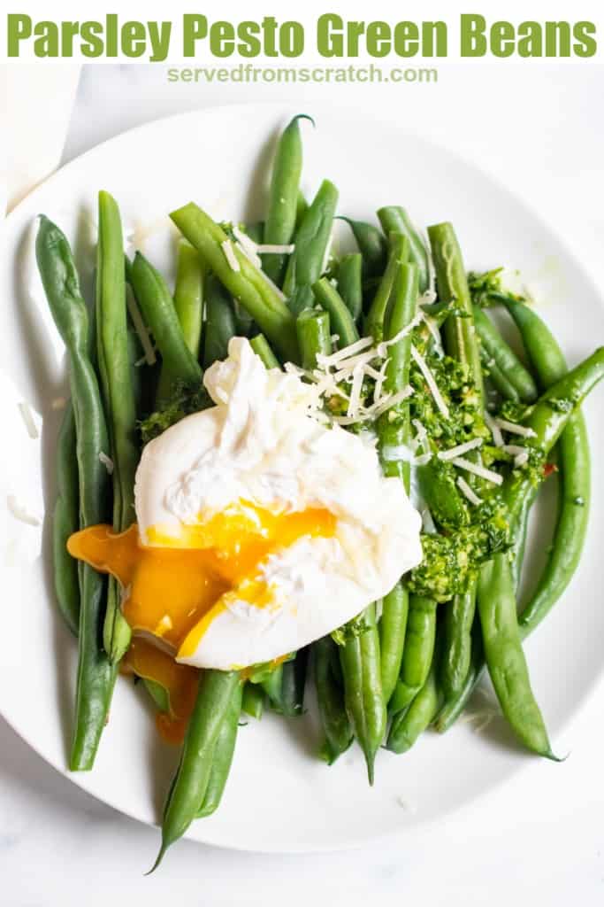 two plates with green beans and pesto and topped with a runny poached egg with Pinterest Pin.