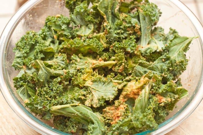 a bowl of kale pieces mixed with paste.