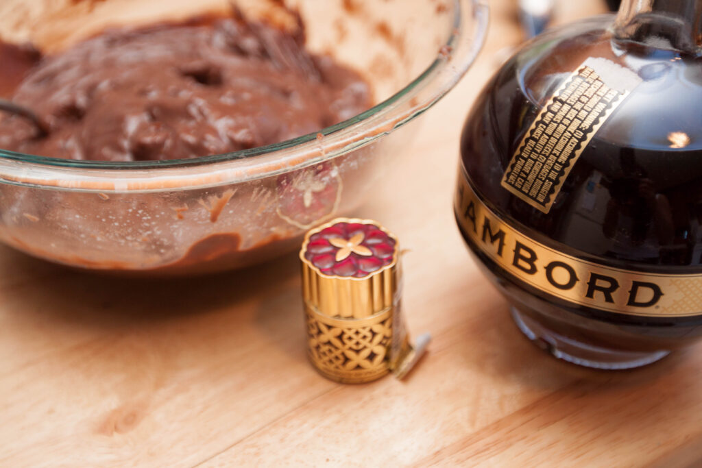 a bowl of chocolate pudding next to a bottle of Chamboard.