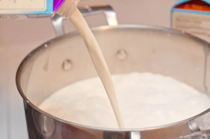 cream being poured into a pot.