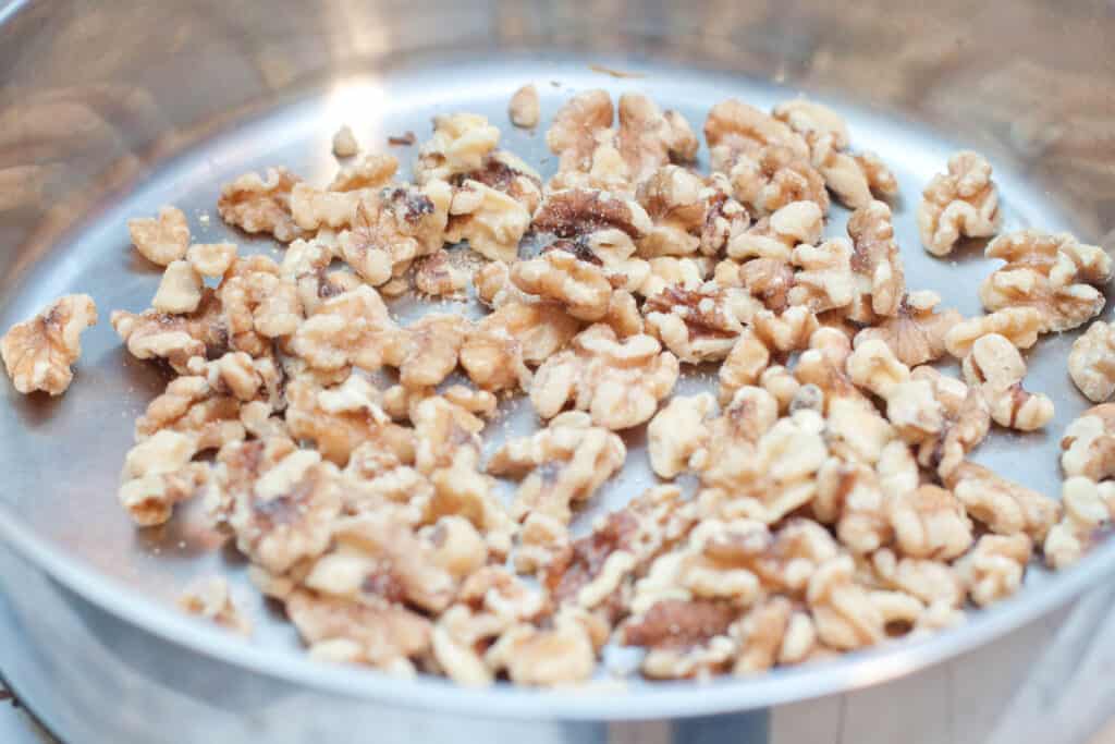 walnuts in a pan toasting.