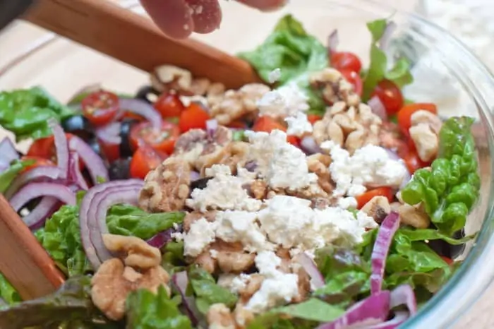 a bowl of salad topped with feta cheese.