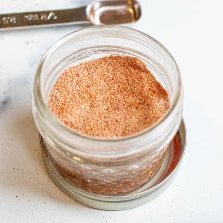 a small open mason jar open with taco seasoning.