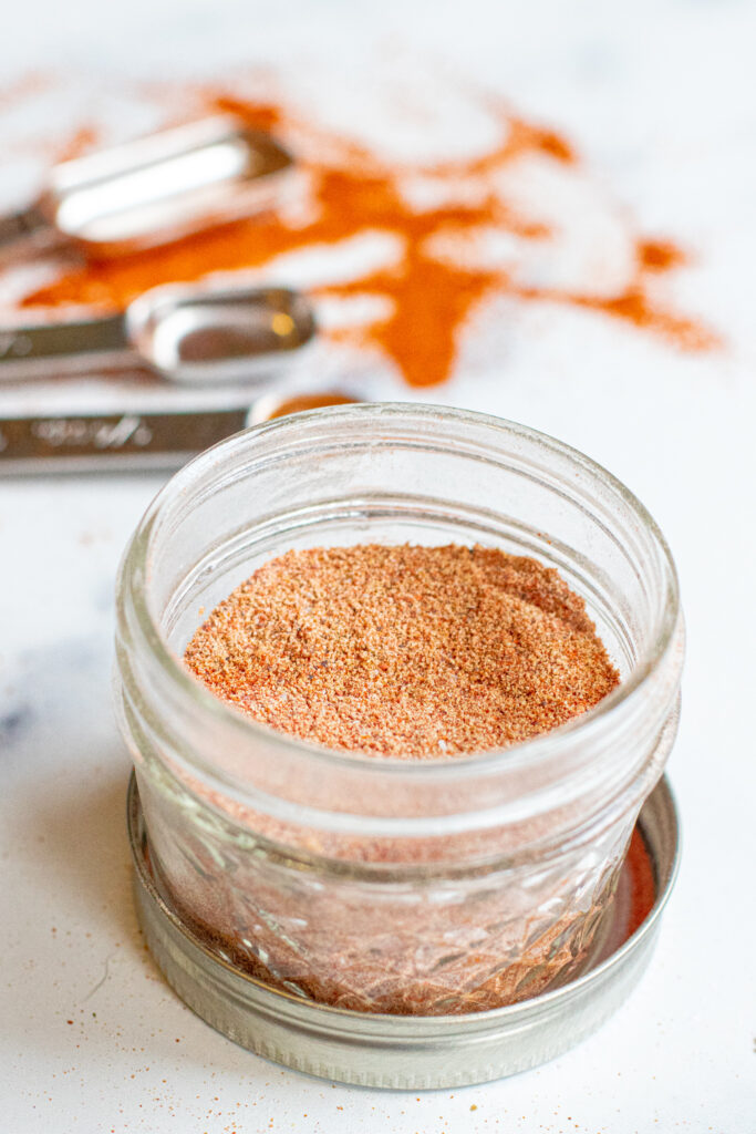 an open mason jar with taco seasoning.