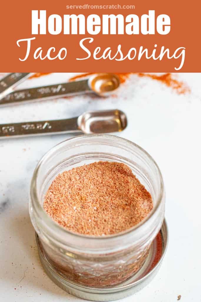 an open jar of taco seasoning with Pinterest pin text.