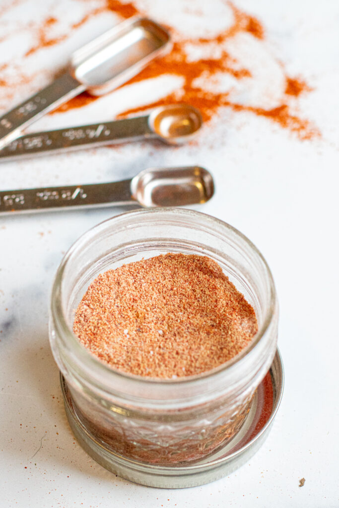 an open mason jar with taco seasoning.