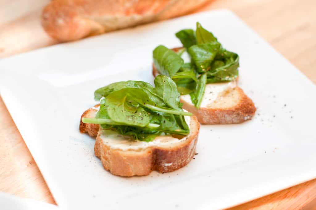 a place with arugula topped crostini.