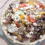 ratatouille with cheese on top in a pie dish