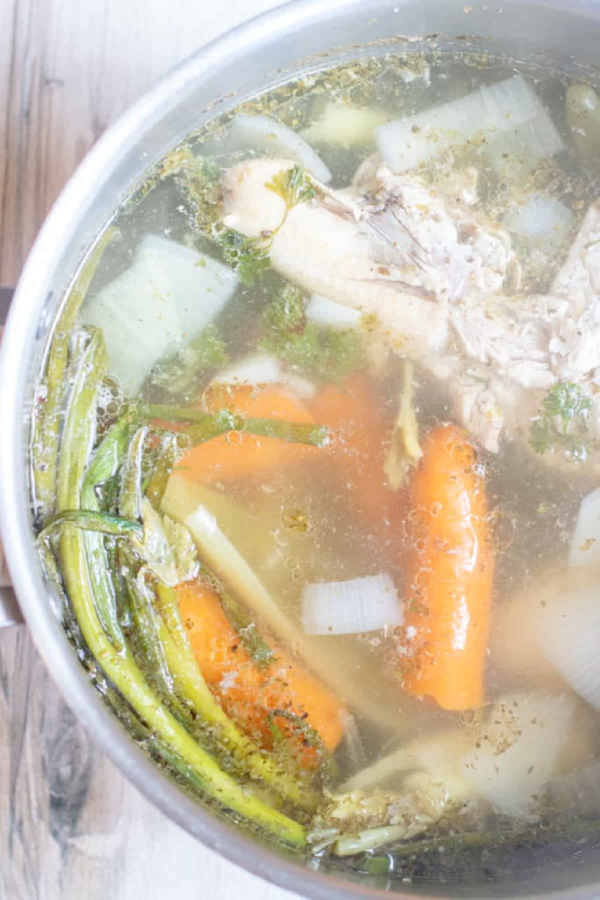 a pot of cooked veggies and chicken for stock.