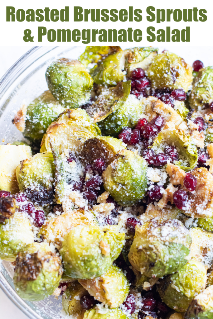 bowl of brussels sprouts and pomegranates topped with cheese with Pinterest pin text.