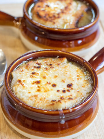 crocks of soup with melted cheese.