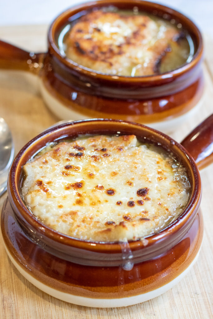 crocks of soup with melted cheese.