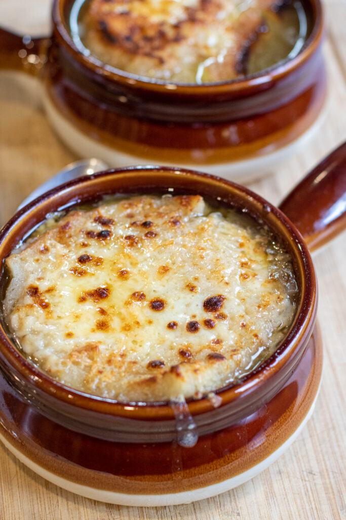 crocks of soup with melted cheese