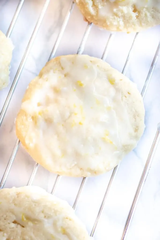 a lemon glazed cookie on a cooling rack.