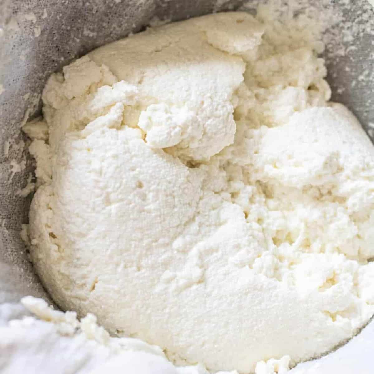 an open cheese cloth of fresh ricotta cheese.