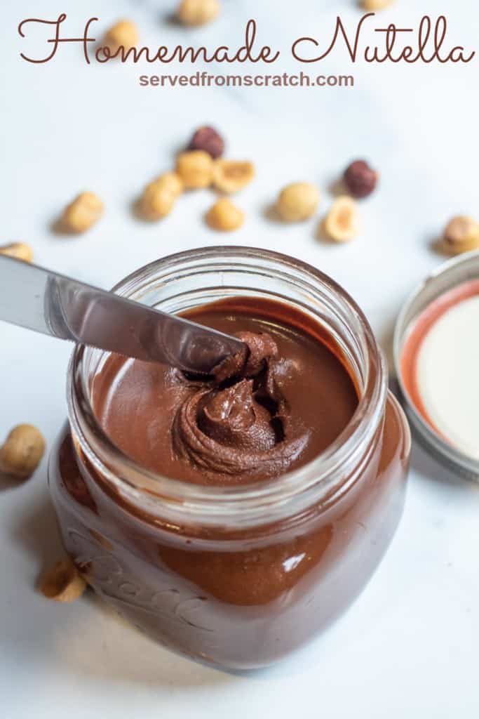 a jar of creamy nutella with a knife in it and Pinterest pin text.