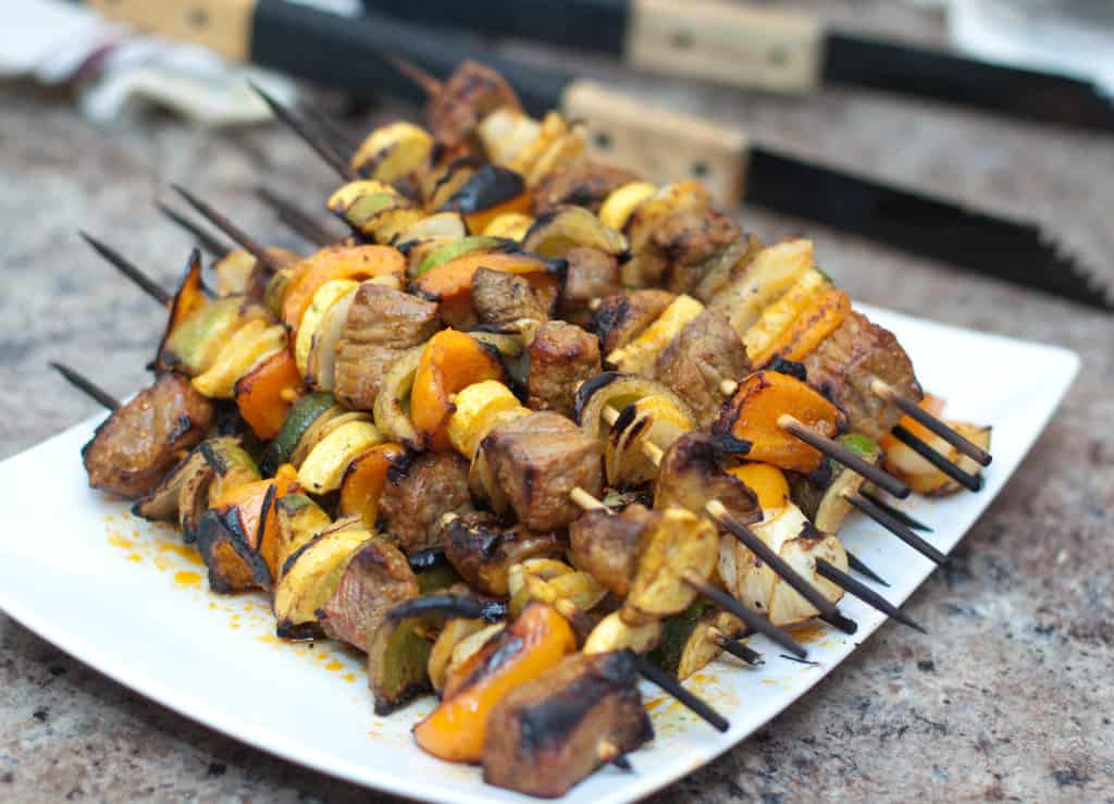 grilled spicy beef kabobs cooked and on a plate.