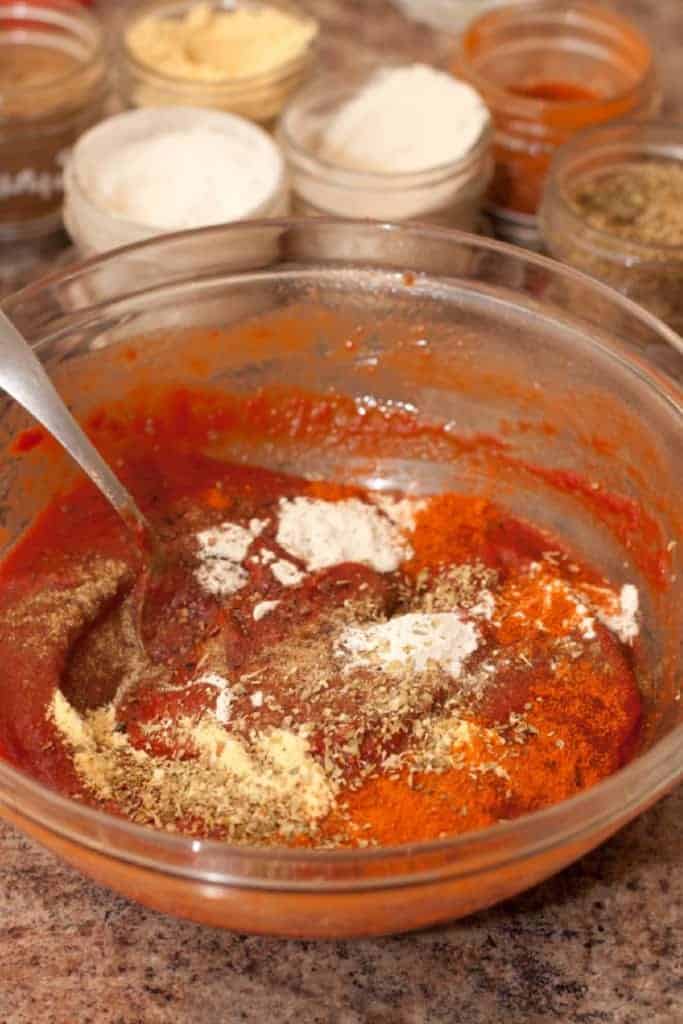 a bowl of tomato paste with spices in it.