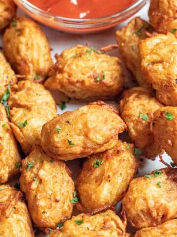 a plate of crispy tater tots.
