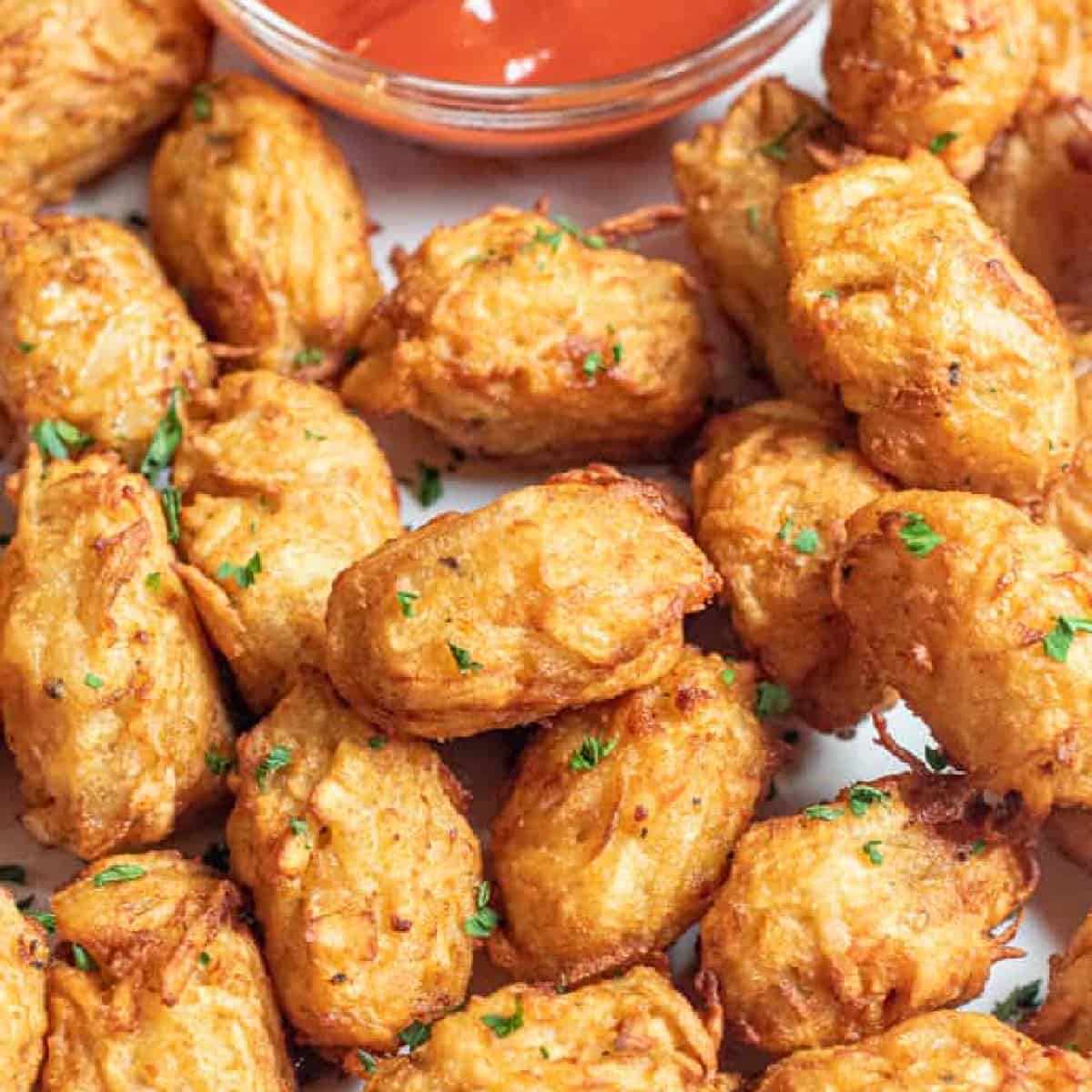 a plate of crispy tater tots.