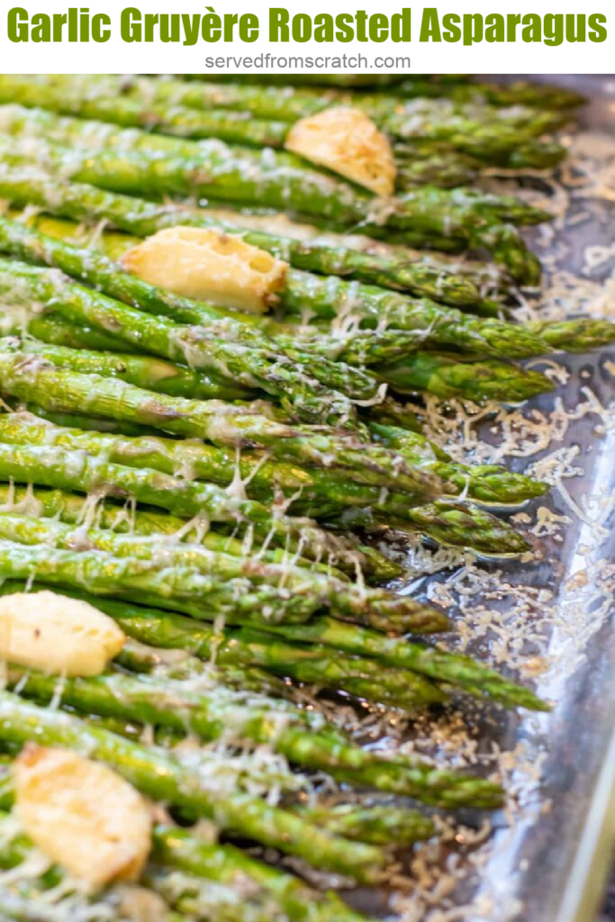 a pan of cooked asparagus with garlic and melted cheese.