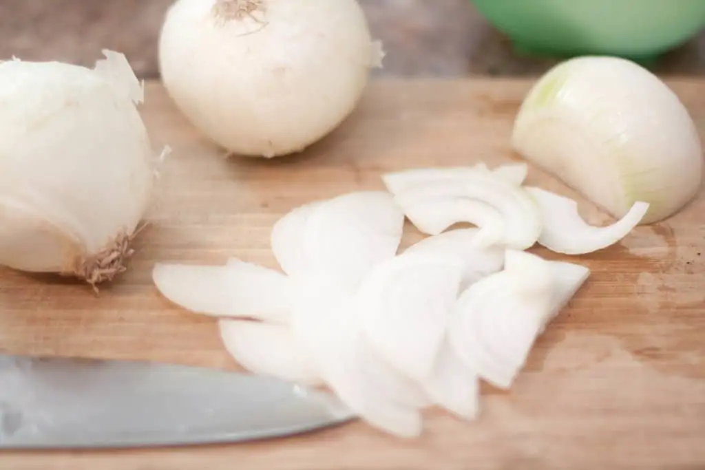 sliced onions on a cutting board.