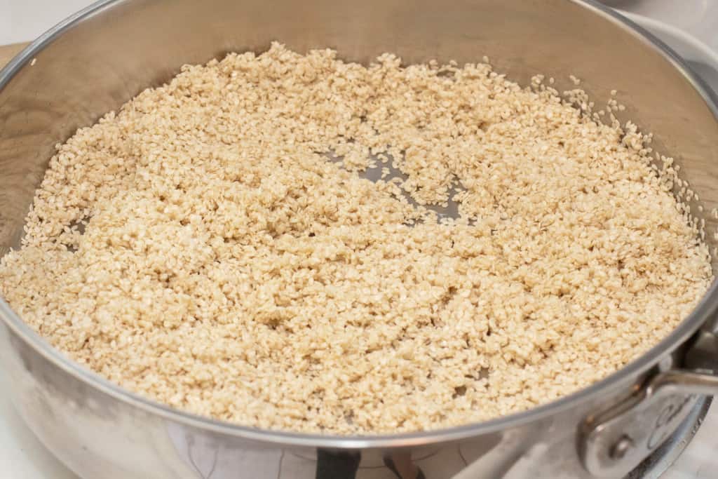 sesame seeds in a saute pan toasting.