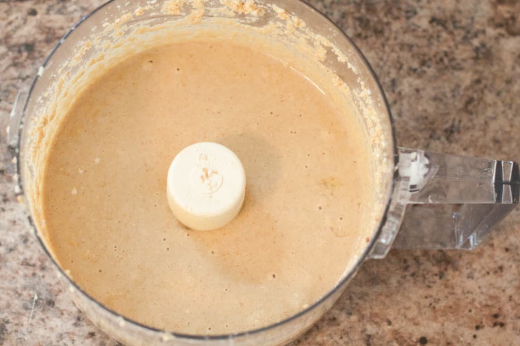 an overhead of a food processor with blended tahini.