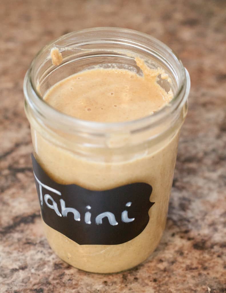 homemade tahini in a mason jar with lid off.