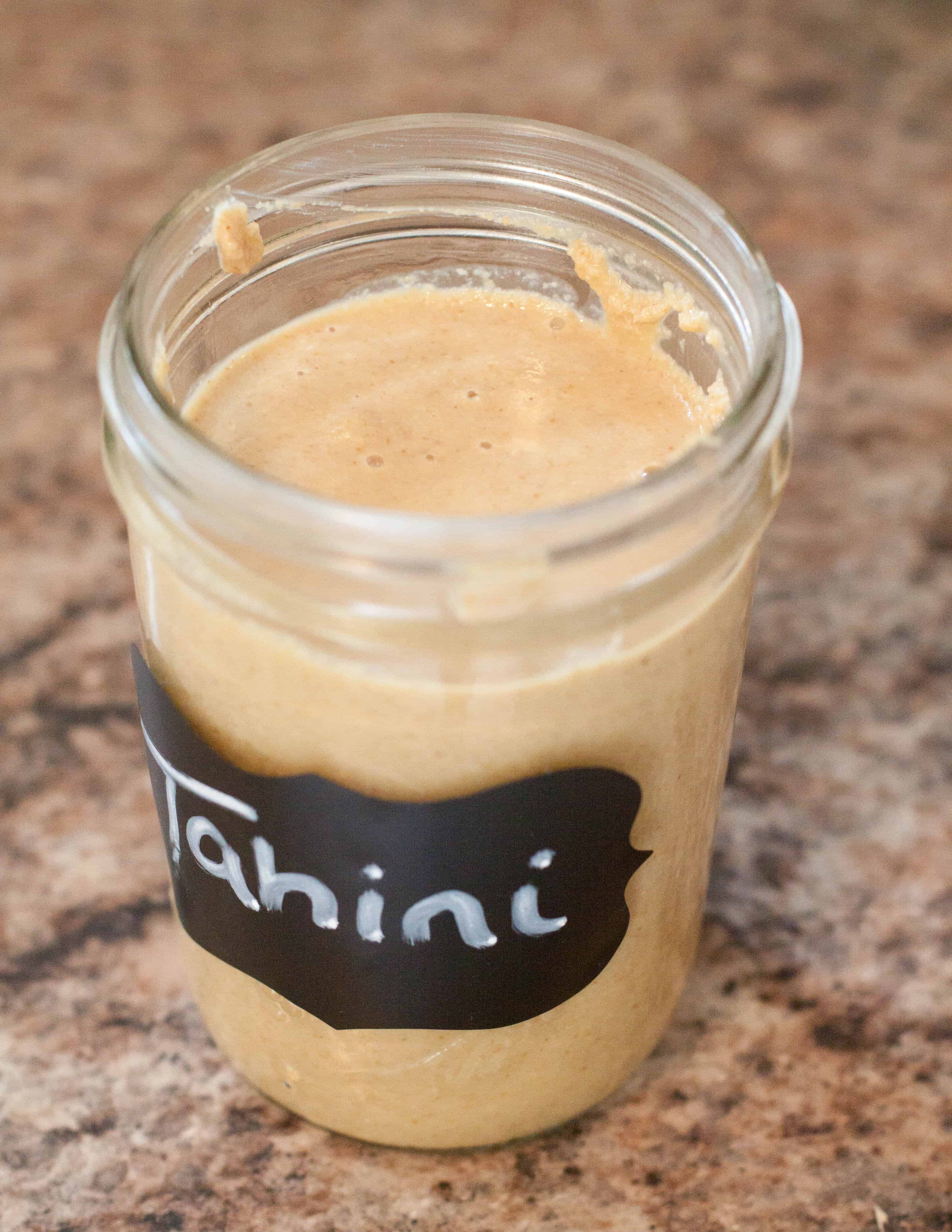 homemade tahini in a mason jar with lid off